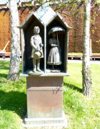 An outdoor bronze sculpture of a weather house by artist Bonifatius Stirnberg in the German city of Bad Sassendorf.